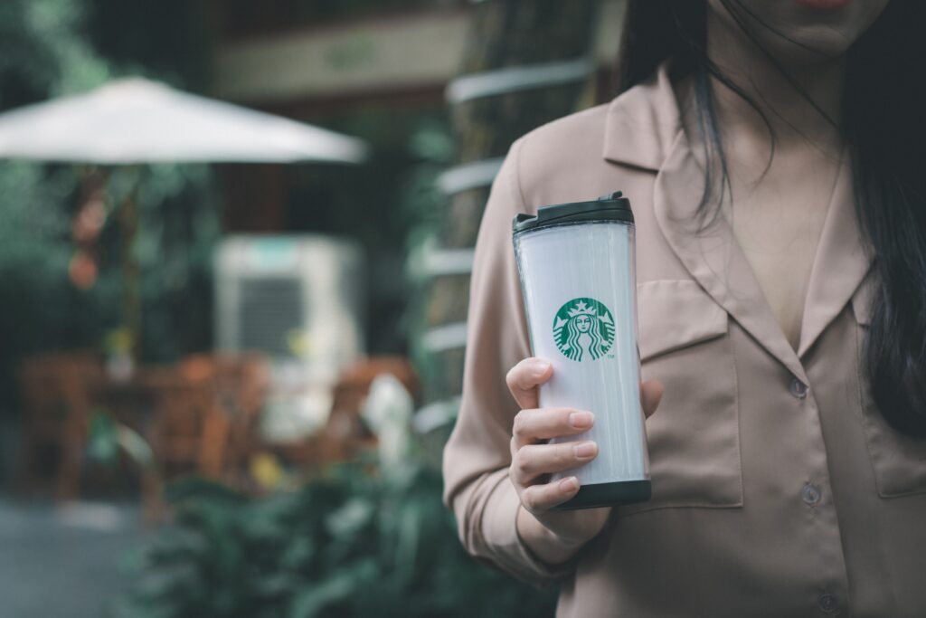 Woman holding Starbucks cup