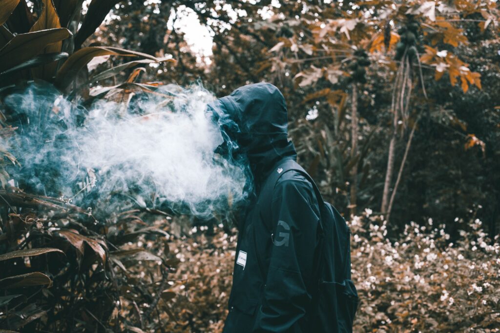 Man smoking in forest